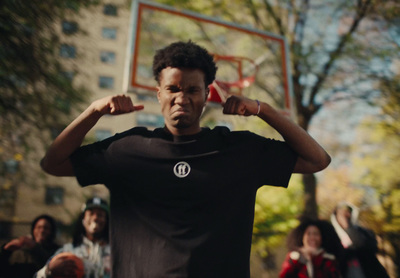 a man holding a basketball in front of a group of people