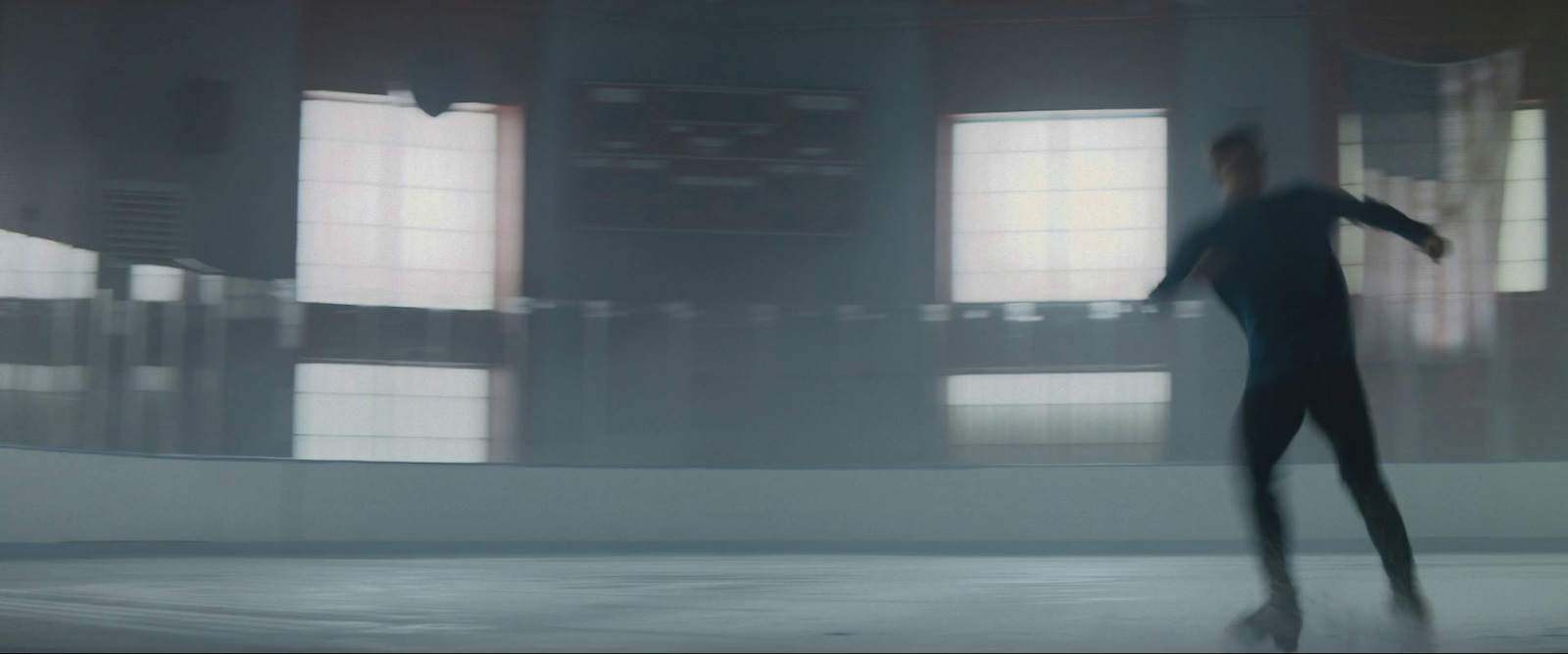 a blurry photo of a man skating on a rink