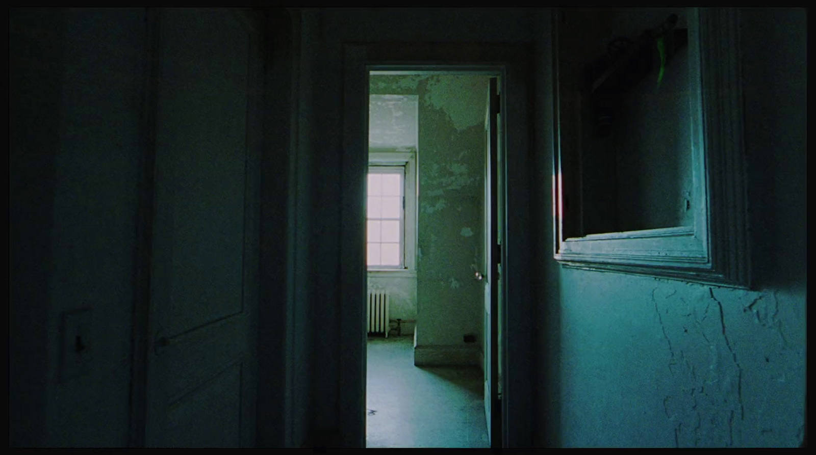 a hallway leading to a bedroom in a house