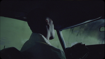 a man driving a car in the dark