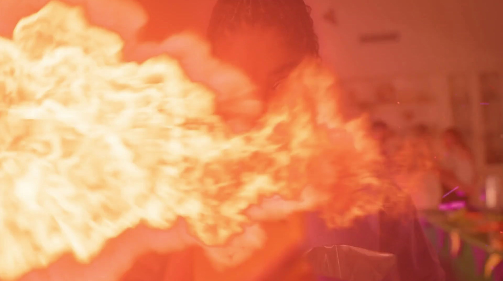 a man holding a large fireball in his hands