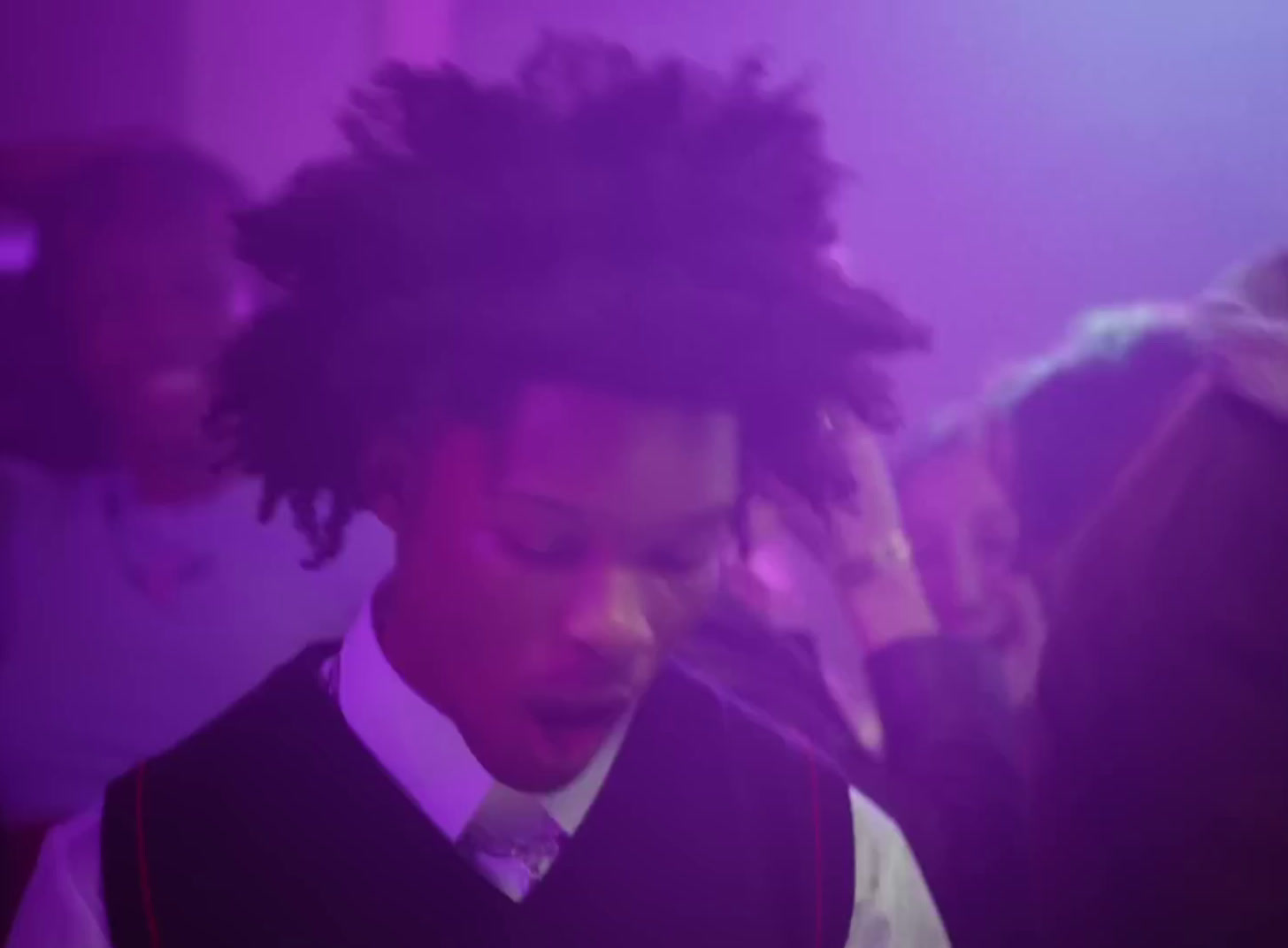 a man with dreadlocks standing in a room