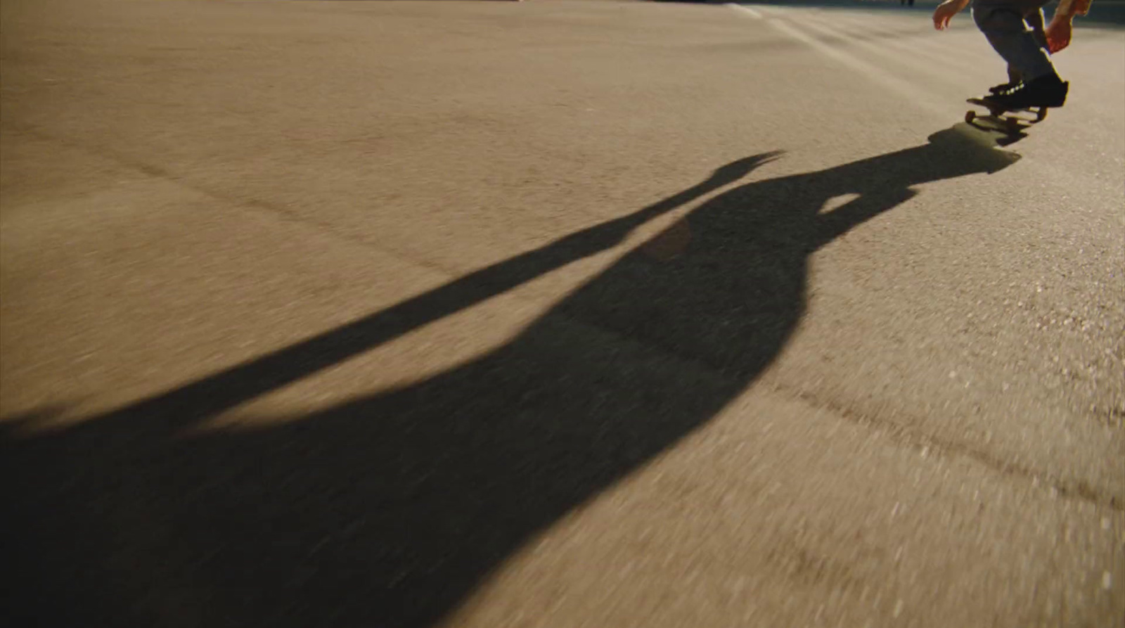 a man riding a skateboard down a street