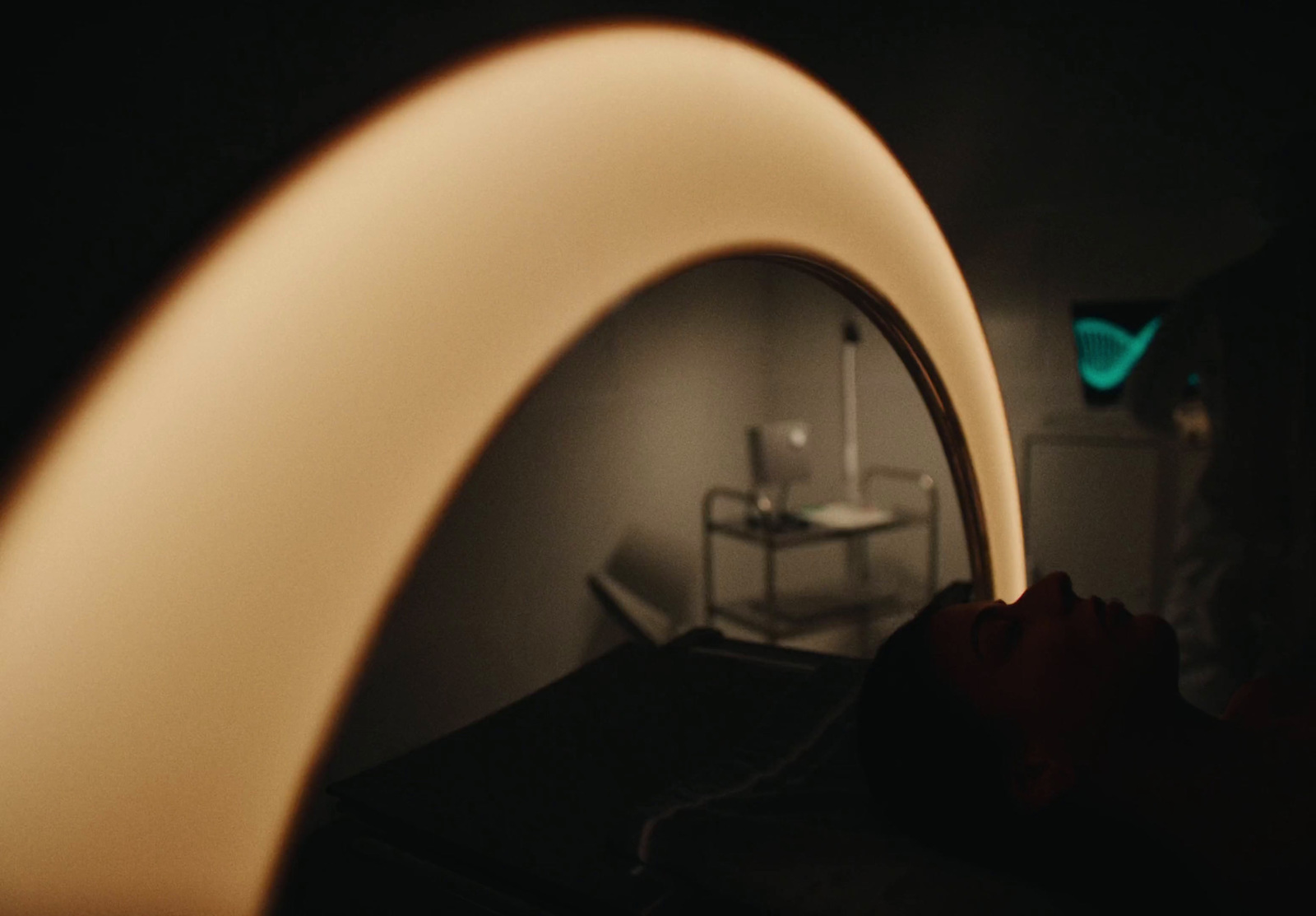 a person holding a white object in a dark room