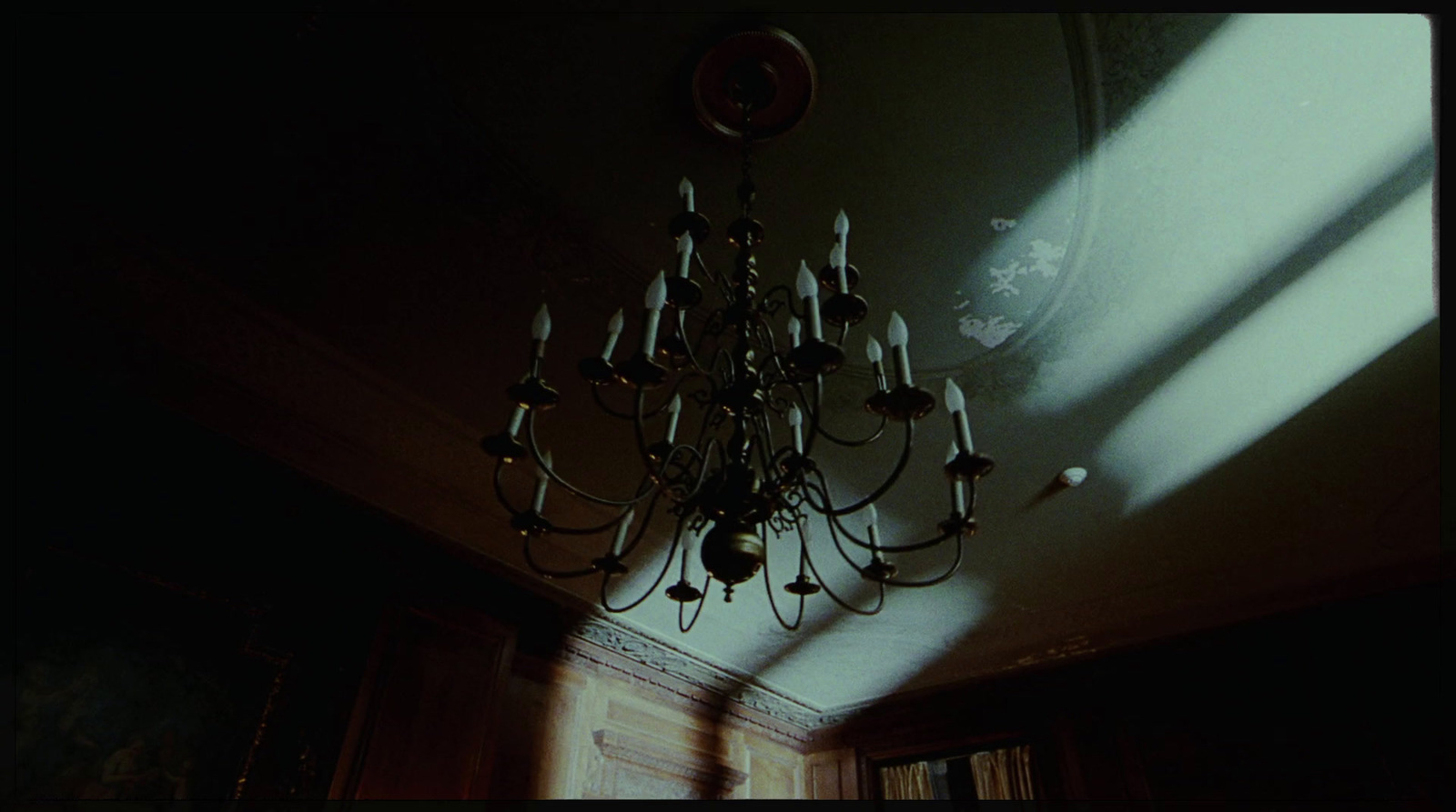 a chandelier hanging from a ceiling in a dark room