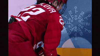 a hockey player in a red uniform and helmet