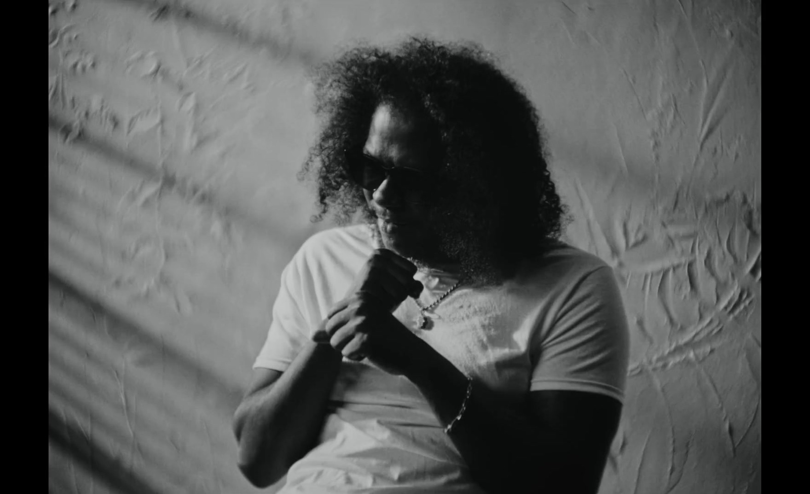 a black and white photo of a man holding a microphone