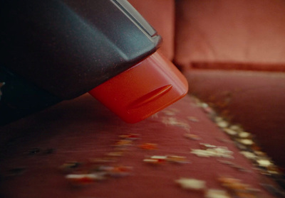 a close up of a red couch with a red cup on top of it