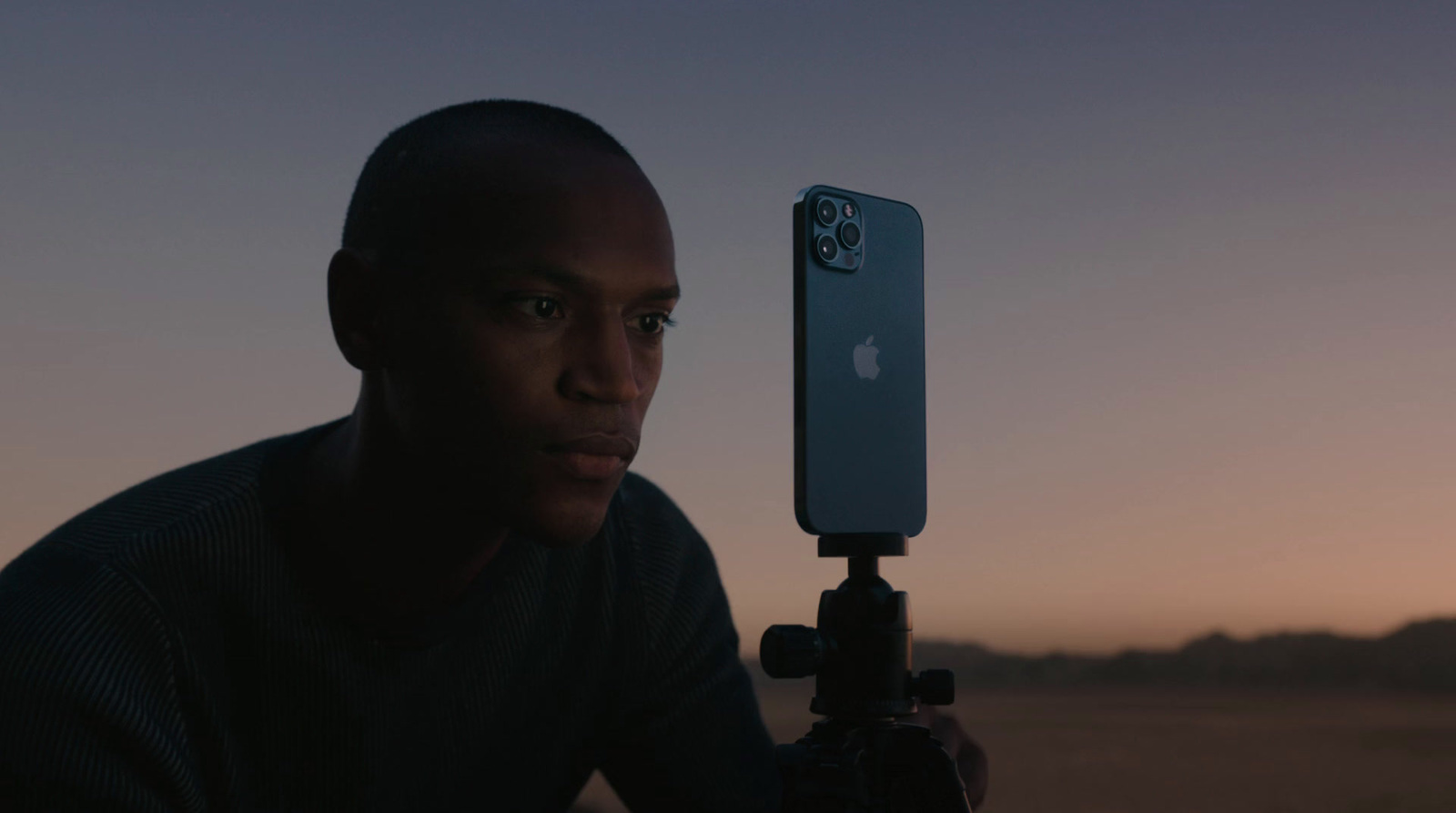 a man holding up a cell phone to take a picture