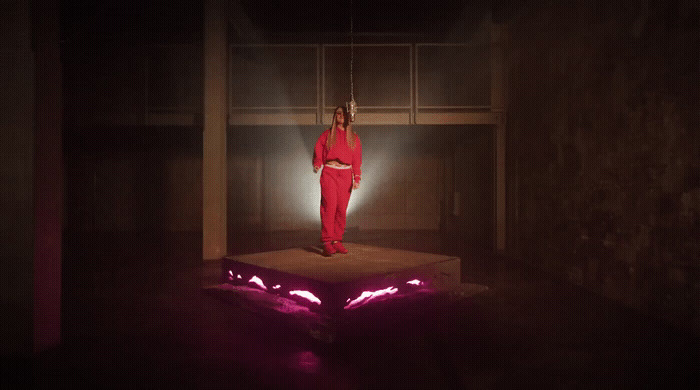 a woman in a red outfit standing on a platform