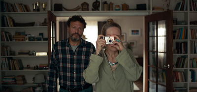 a man and woman taking a picture of themselves in a mirror