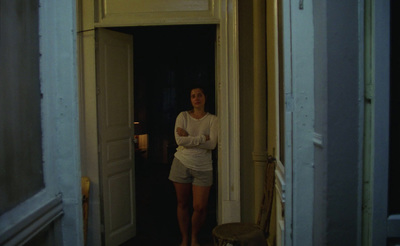 a woman standing in the doorway of a house