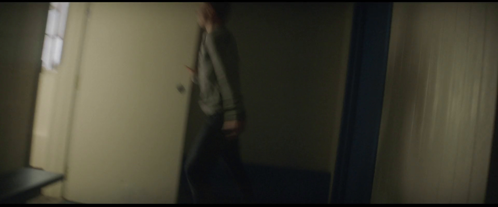 a person standing in a room with a door open