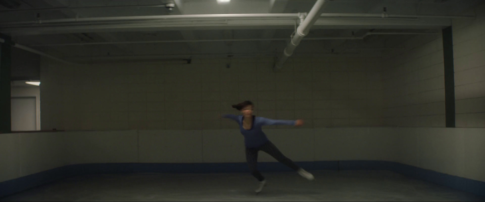 a woman is dancing in a large room