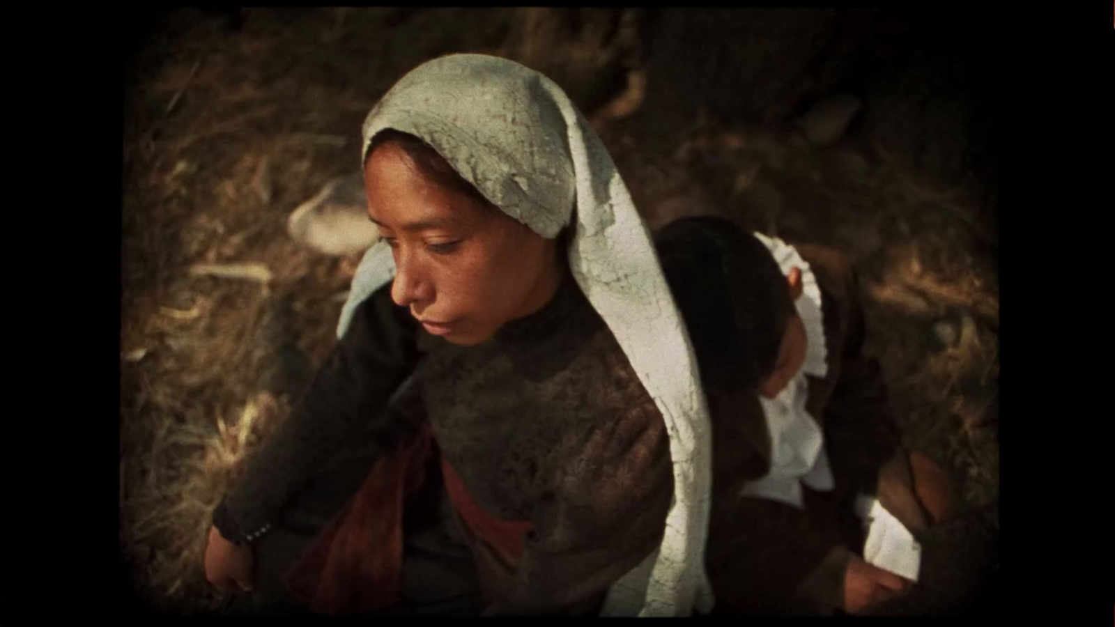 a young girl in a nun costume looking down