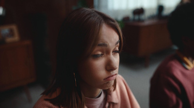 a woman sitting next to a man in a room