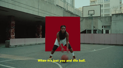 a woman is playing basketball on a basketball court