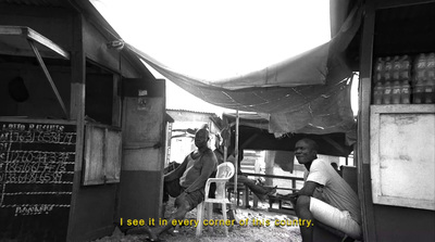 a black and white photo of two people in a shack