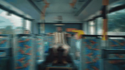 a blurry photo of a man riding a bus