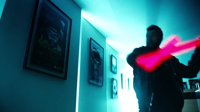 a man standing in a hallway holding a red frisbee