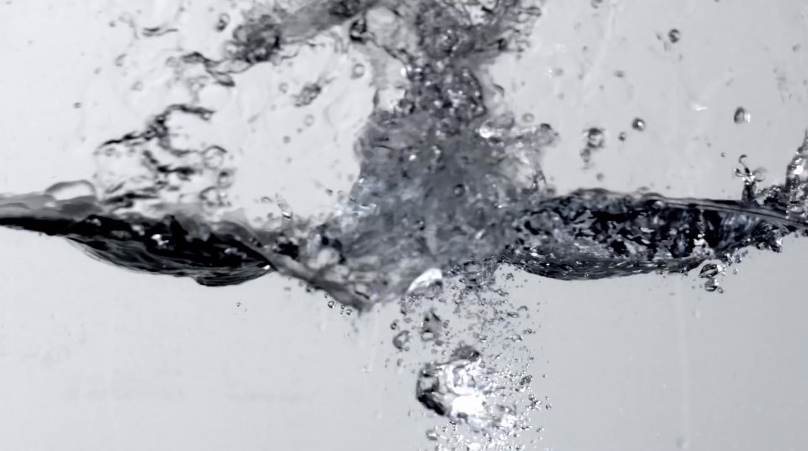 water splashing into the air with a white background