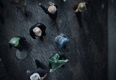 a group of people walking down a street holding umbrellas