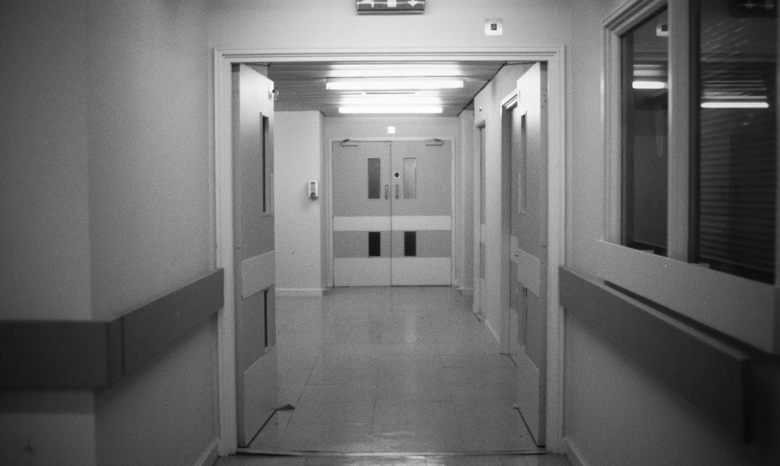 a long hallway with white walls and doors