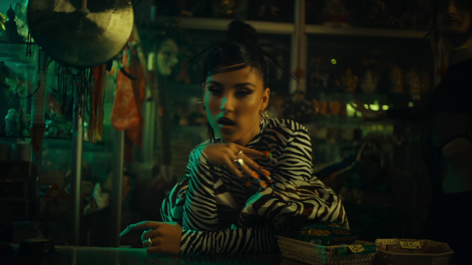 a woman sitting at a table with a cigarette in her hand