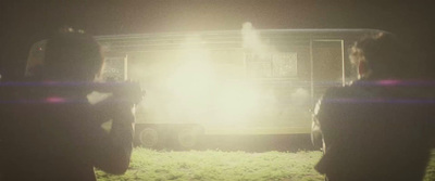 a couple of people standing in front of a truck