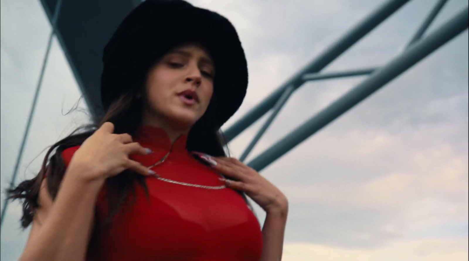 a woman in a red dress and a black hat