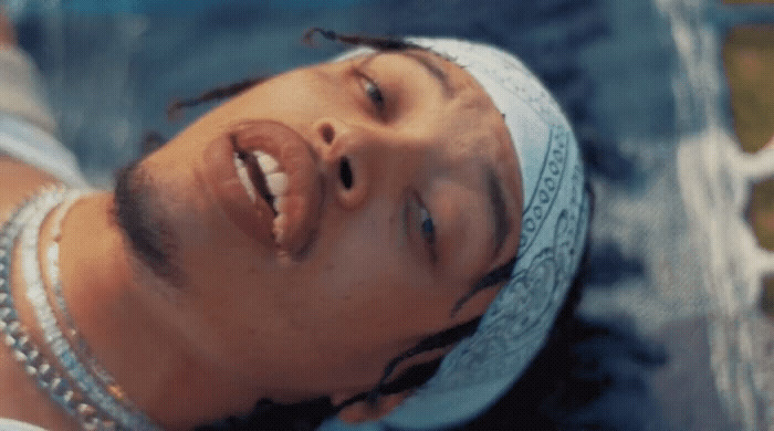 a close up of a person wearing a bandana