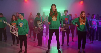 a group of people standing in a room with guitars