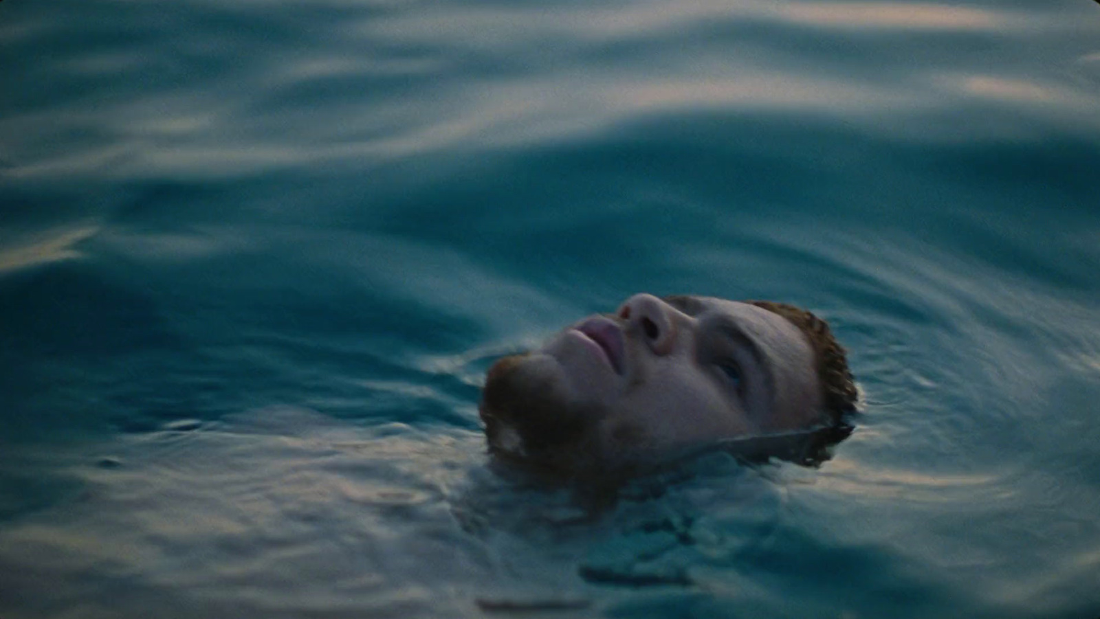 a man swimming in a body of water