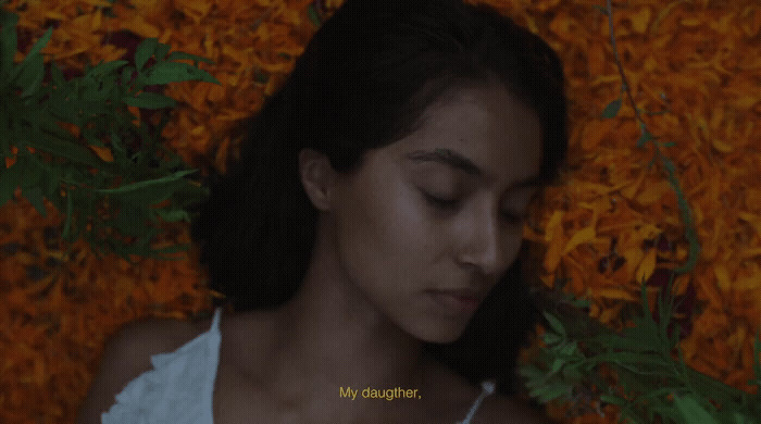 a woman laying on a bed of yellow flowers