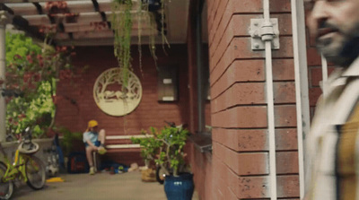 a man standing in front of a brick building