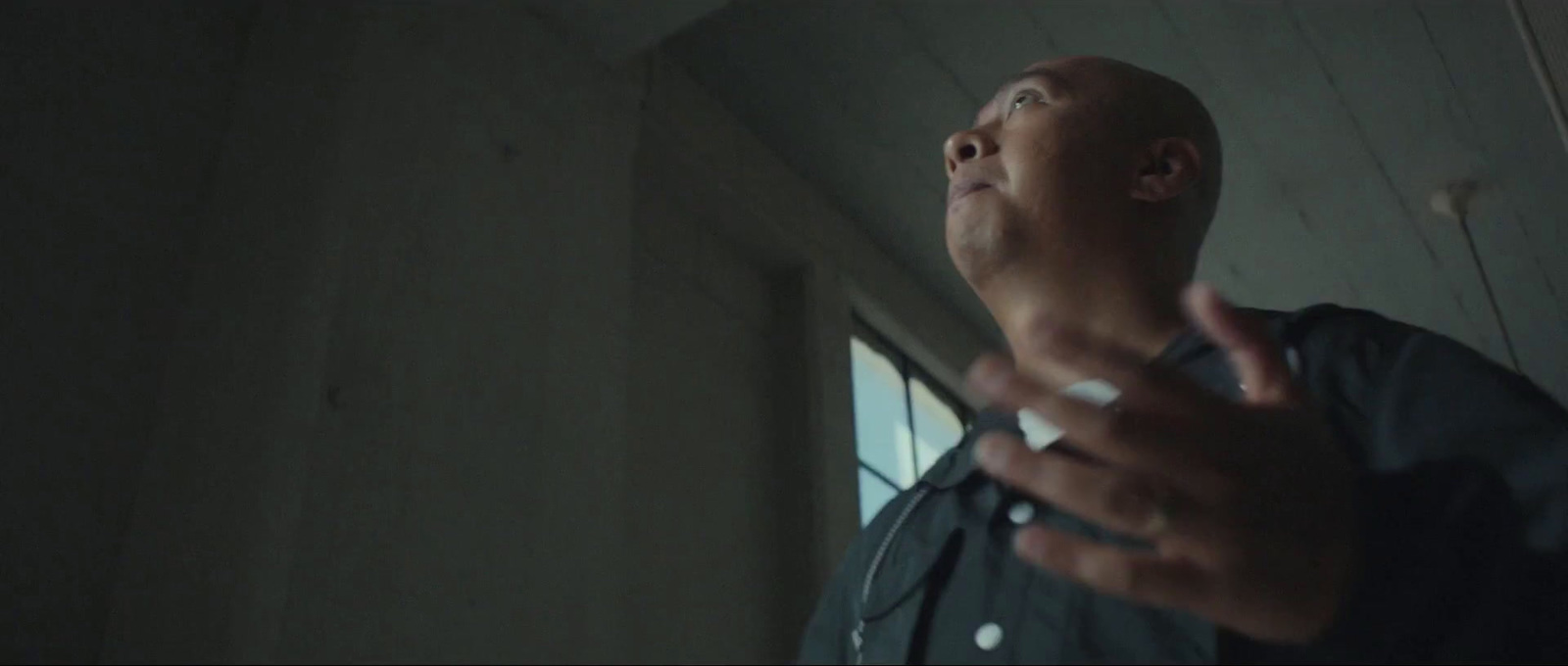 a man standing in a room with a cigarette in his hand