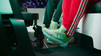 a pair of legs with green and white sneakers