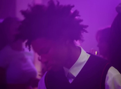 a man with dreadlocks standing in a room