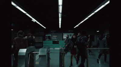 a group of people walking through a train station