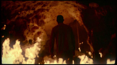 a man standing in front of a fire pit