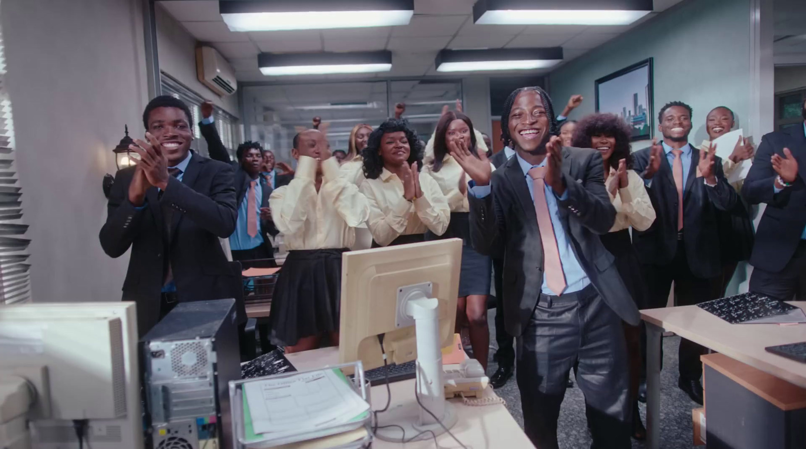 a group of people standing in an office