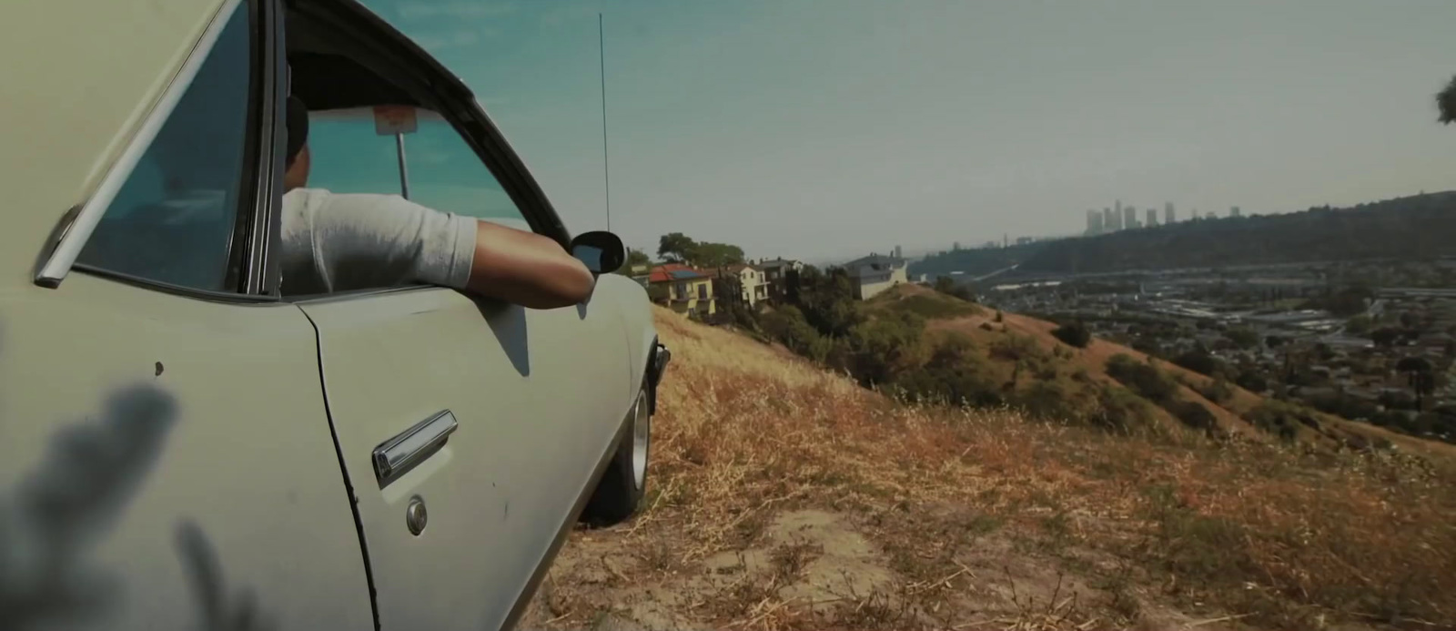 a person is sitting in a car looking out the window