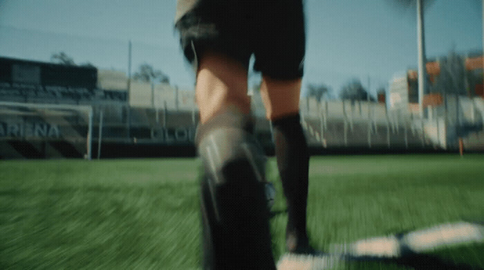 a soccer player is walking across the field