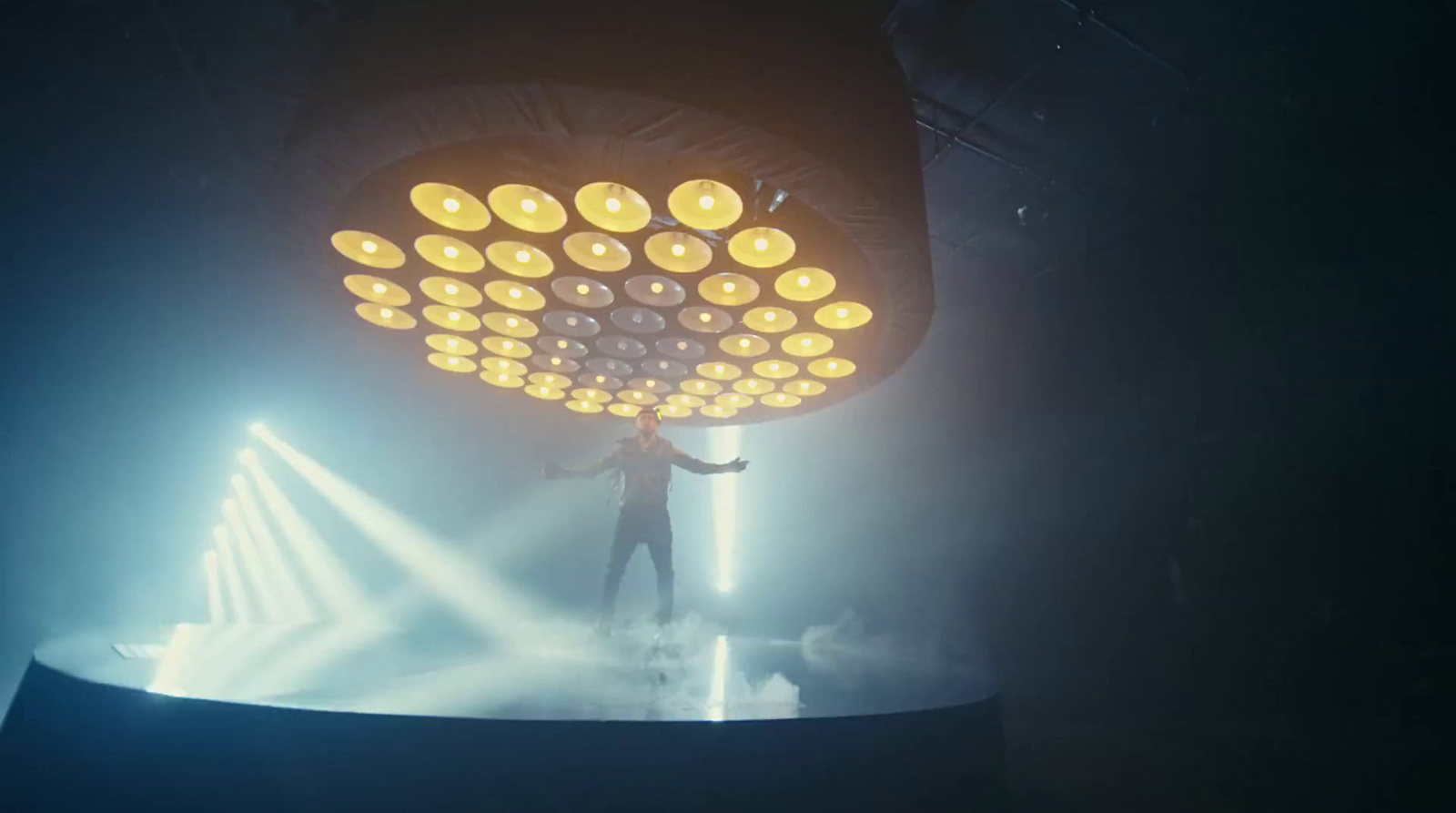 a person standing on a stage holding a light