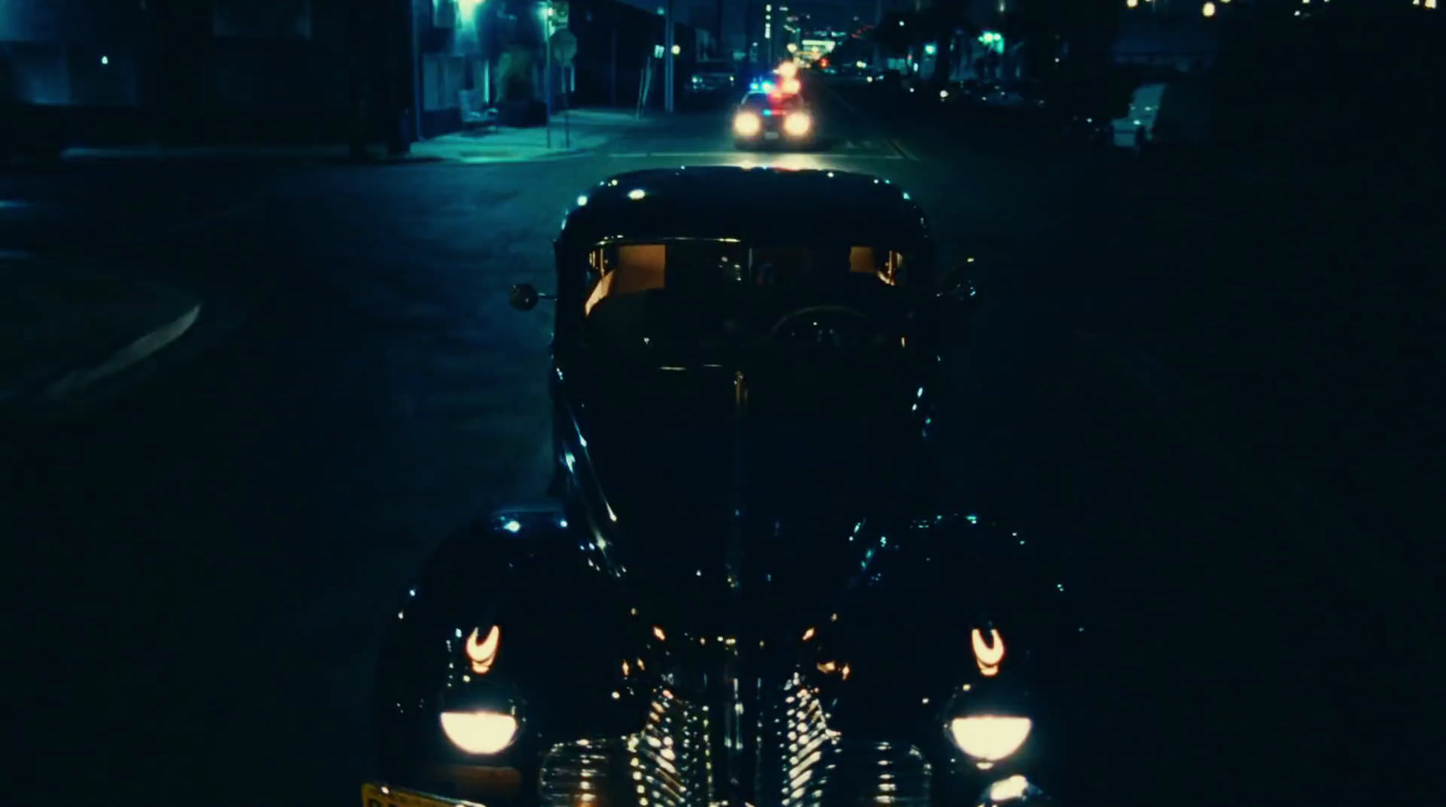 a car parked on the side of the road at night