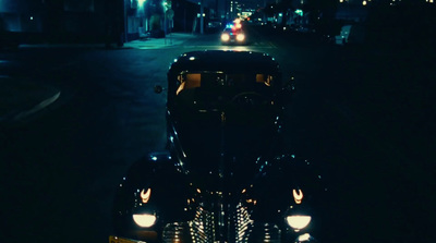 a car parked on the side of the road at night