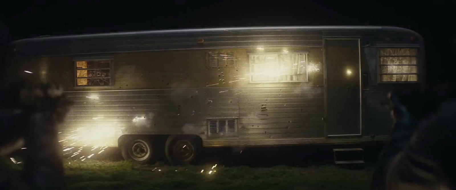 a person standing in front of a trailer at night