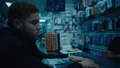 a man sitting at a counter in a store