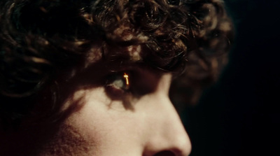 a close up of a person with curly hair