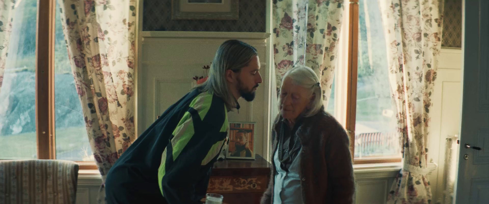 a man standing next to a woman in a living room